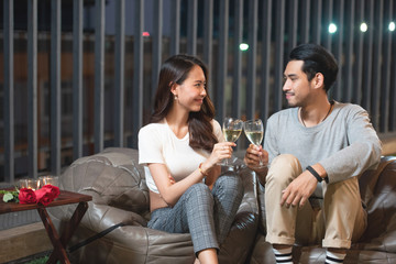 asian couple toast wine celebrate in nightclub