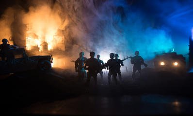 War Concept. Battle scene on war fog sky background, Fighting silhouettes Below Cloudy Skyline at night.