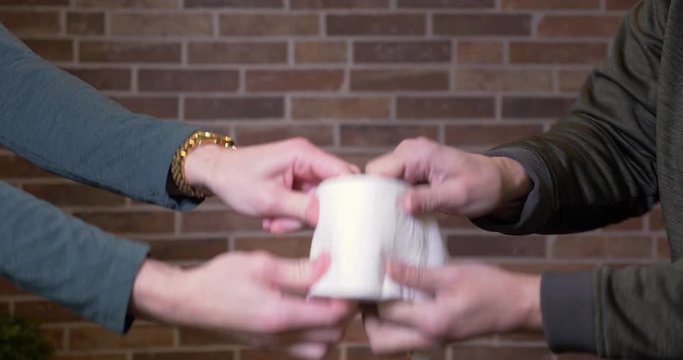 Two men fight over the last roll of toilet paper.  	