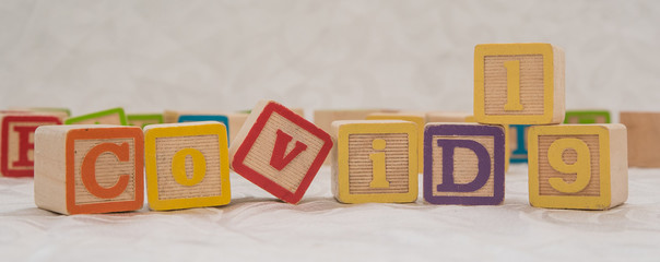 Kid Cubes spelling COVID-19 for Business Health