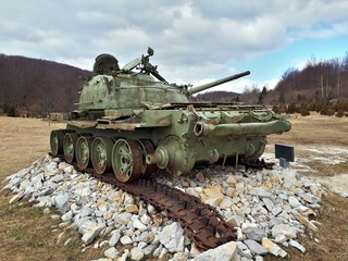 Old soviet tank destroyed in 90's, now placed on a meadow as a monument