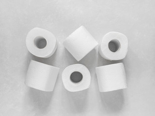 Toilet paper rolls on white background. Top view, copy space
