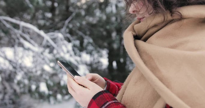 Young Fashion Girl Scroll The Smart Phone, Winter Forest