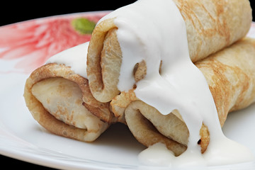 Homemade thin pancakes with cottage cheese and sour cream, very tasty and healthy food.