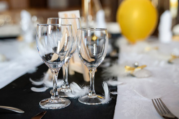 Table set with glasses, wine, alcohol and champagne for a celebration or a wedding