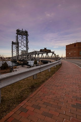 Sunset view of Memorial Bridge from sidewalk - Portsmouth, New Hampshire.