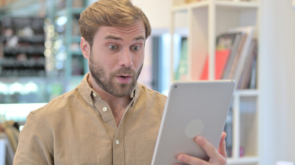 Wow, Excited Young Man in Shock on Tablet 