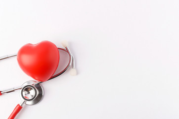 Stethoscope with red heart on white background.