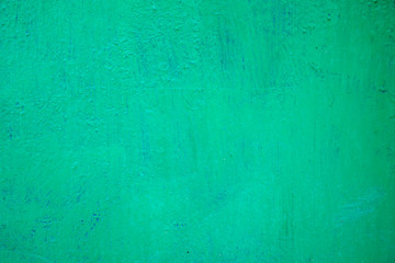 Texture of an iron wall covered with green oil paint.
