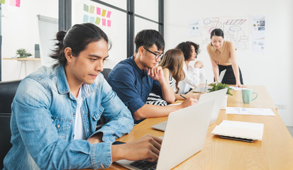 Asian business people working with laptop, searching data for business startup plan and strategy