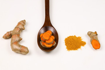 Turmeric powder and fresh turmeric roots isolated on a white background are ingredients in turmeric foods and ingredients in skin care products. Turmeric helps the skin to be strong.