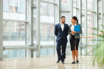 Business people walk together
