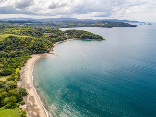 Aerial shot of the tropical beach Playa Arenillas in Costa Rica in peninsula Papagayo coast in guanacaste - obrazy, fototapety, plakaty