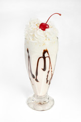 Milkshake with whipped cream in a glass on a white background