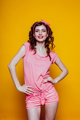 Portrait of a beautiful fashionable pinup woman in pink dress