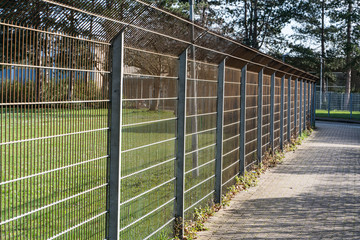 Steel fence on a footpath in the suburbs. Panorama
