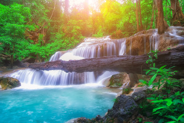The beautiful Erawan cascade waterfall with turquoise water like heaven and sunlight at the...