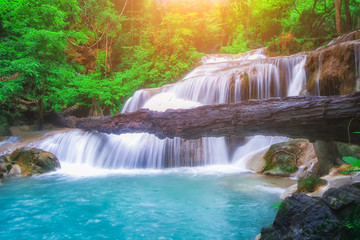Fototapeta na wymiar The beautiful Erawan cascade waterfall with turquoise water like heaven and sunlight at the tropical forest ,Kanchanaburi National Park, Thailand