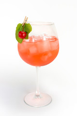 Cocktail in a glass with a cherry on a clothespin
