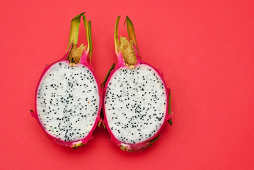 Two halfs of dragon fruit pitahaya beautiful picture on the red background