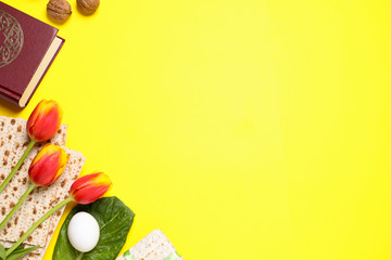 Flat lay composition with symbolic Pesach (Passover Seder) items on yellow background, space for...