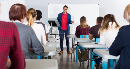 Male student answering at whiteboard