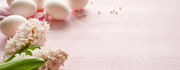 Easter pastel pink background with fresh hyacinths and eggs with copy space