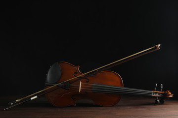 Classic violin and bow on wooden background