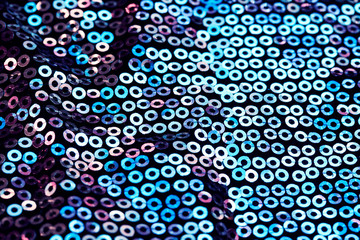 horizontal shiny textured background with iridescent round sequins are sewn on the fabric