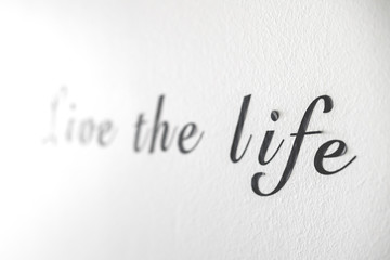 Live the life word phrase on a white wall