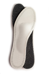Isolated orthopedic insole on a white background. Treatment and prevention of flat feet and foot diseases. Foot care, comfort for the feet. Wear comfortable shoes. Medical insoles.