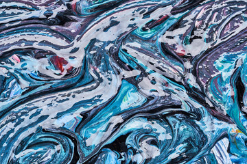 Texture and strokes of multicolored acrylic paint with sparkles on a white background