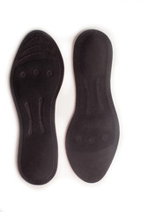 Isolated orthopedic insole on a white background. Treatment and prevention of flat feet and foot diseases. Foot care, comfort for the feet. Wear comfortable shoes. Medical insoles.