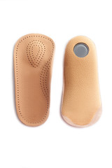 Isolated orthopedic insole on a white background. Treatment and prevention of flat feet and foot diseases. Foot care, comfort for the feet. Wear comfortable shoes. Medical insoles.
