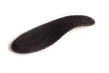 Isolated orthopedic insole on a white background. Treatment and prevention of flat feet and foot diseases. Foot care, comfort for the feet. Wear comfortable shoes. Medical insoles.