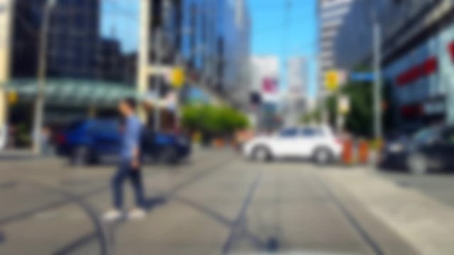 *Reverse Motion* Pedestrians and Traffic Crossing Downtown City Street With Blur Effect Backward.  People Walking and Vehicles Driving Across Urban Road Intersection Fast Speed Motion.