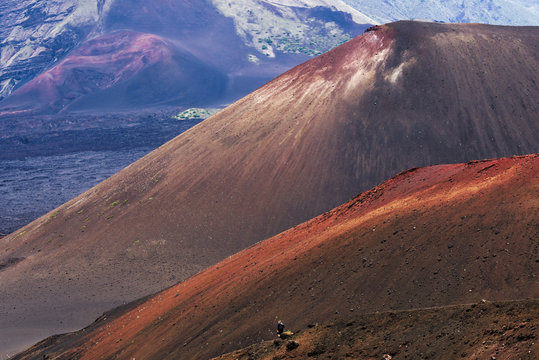 A hiker descends a trail into the crater of Haleakala