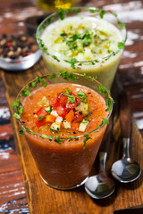 cold soups. red and green gazpacho in glasses, vertical top view