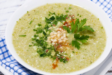 cold green gazpacho in a bowl, closeup