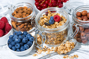 healthy banana granola and breakfast ingredients on white table