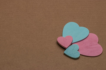 Obraz premium A blue and pink decorative heart lies on brown cardboard. Symbol of masculine and feminine. The problem of recycling paper and raw materials.