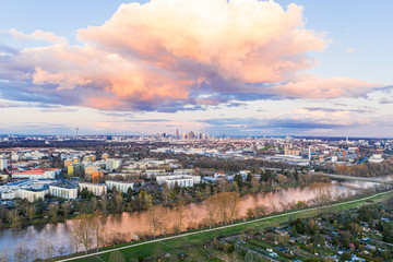 Aerial panoramic picture of river Main and the Frankfurt skyline during sunset in afterglow with illuminated cloud
