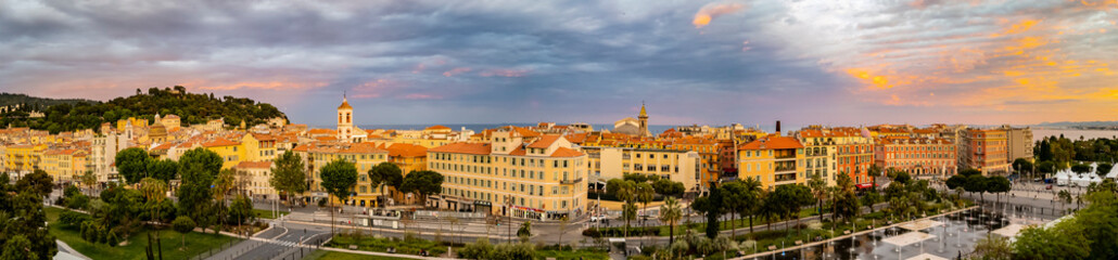Aerial panoramic view of Old Town Vielle Ville and reflecting fountains on Promenade du Paillon at sunset in Nice France