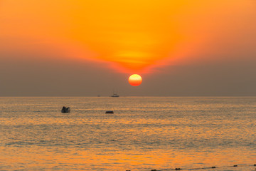 round red sun down to the sea at Patong beach, Phuket,Thailand.