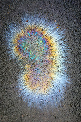 Petrol Gasoline Oil Spill on The Road Tarmac Rainbow Colour Pollution