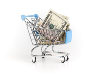 Dollars are in a small shopping cart. Finance savings concept.