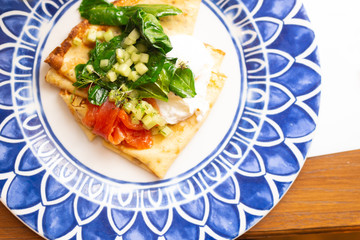 Top view crepes with salmon and poached egg.Tasty breakfast with pancakes, smoked salmon, with spinach, bright color 