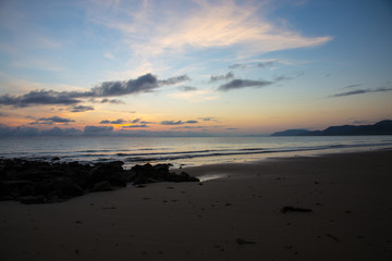 Sunrise at Four Mile Beach, Port Douglas, Queensland, Australia. Calm ocean and colorful horizon early in the morning.