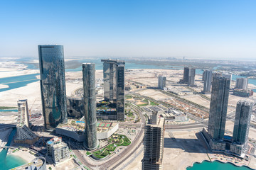 Aerial high shot of Al Reem island Sun and Sky towers, Gate towers and other landmarks in Abu Dhabi city, UAE - obrazy, fototapety, plakaty