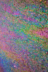 Petrol Gasoline Oil Spill on The Road Tarmac Rainbow Colour Pollution